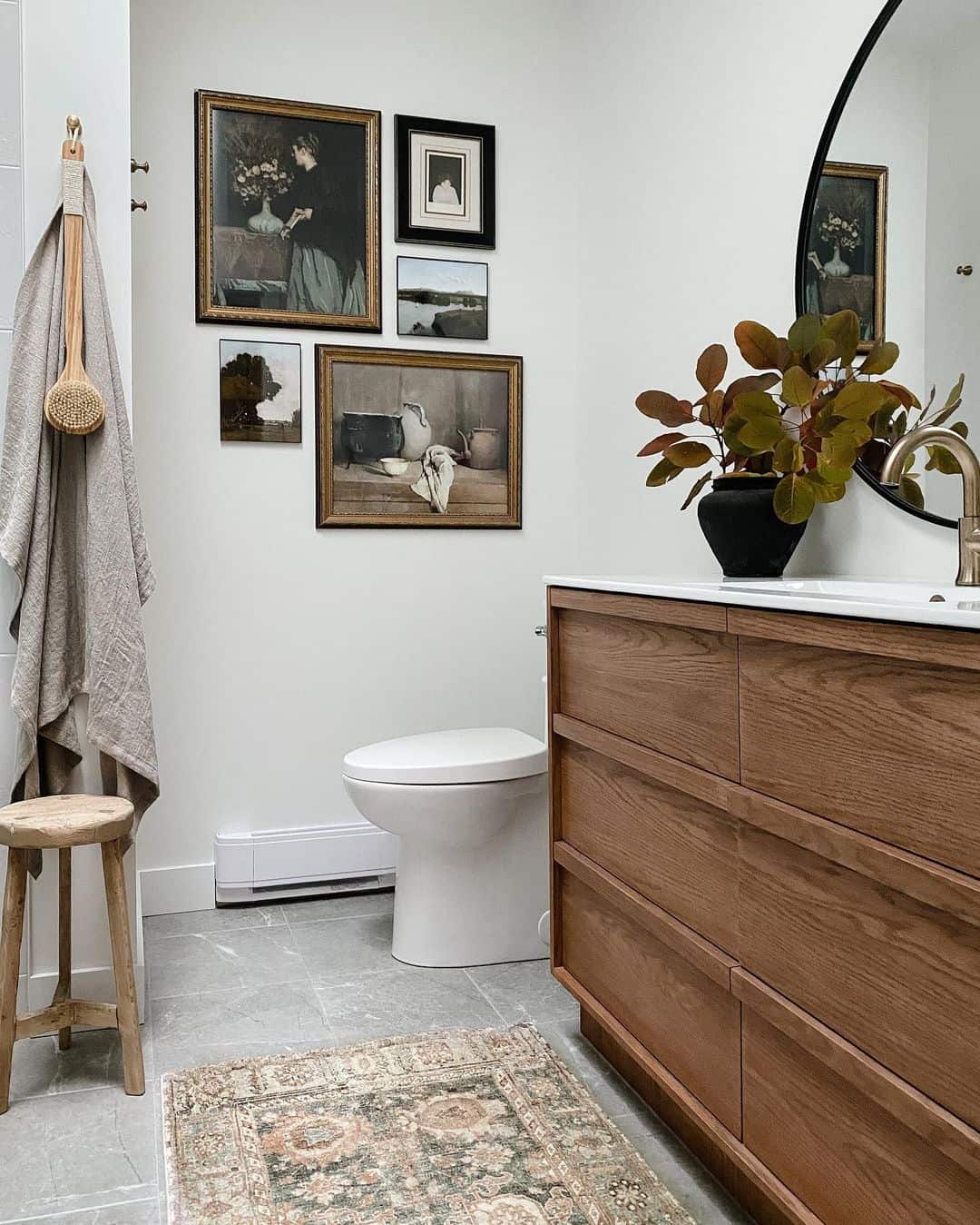 Gallery Wall of Vintage Art Adds Character Above Toilet