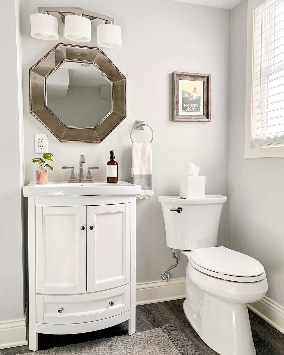 Framed Nautical Art Adds Coastal Charm Above Toilet