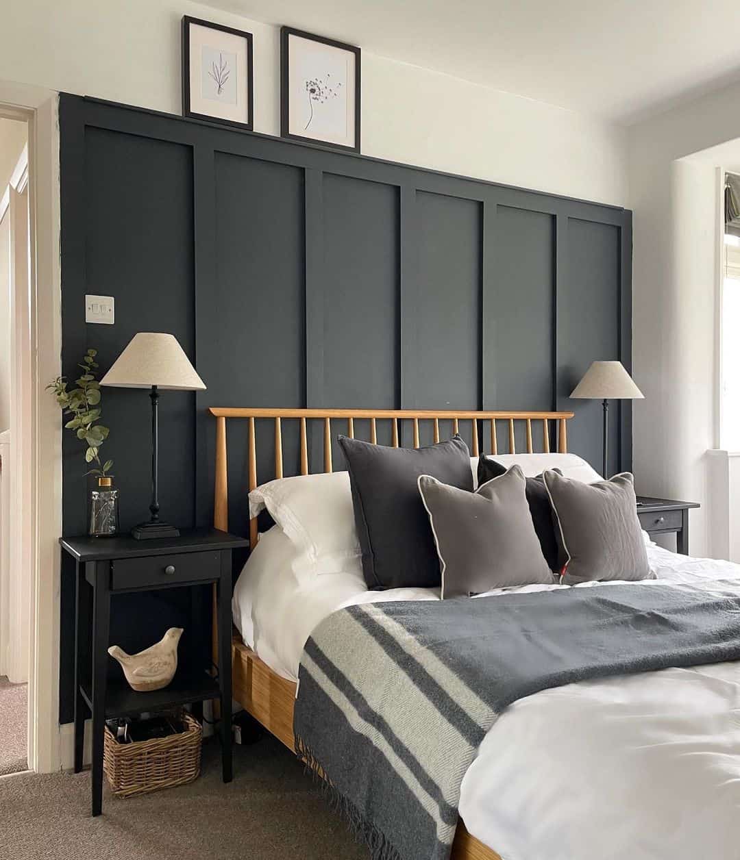 Dark Panel Wainscoting Creates a Moody Headboard Accent