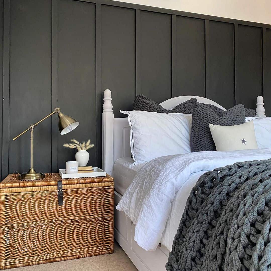 Vertical Paneling Contrasts with a White Bed Frame