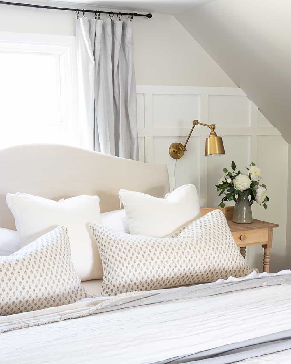 Square Panels Host a Brass Swing-Arm Lamp
