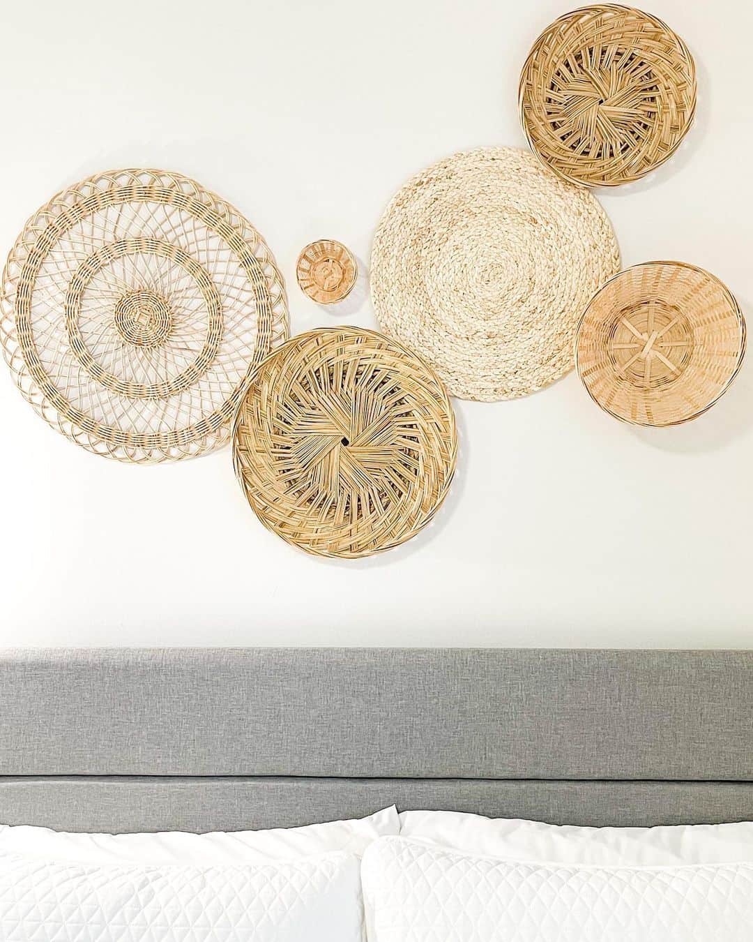 Round Woven Wall Plates Add Natural Texture Above a Bed