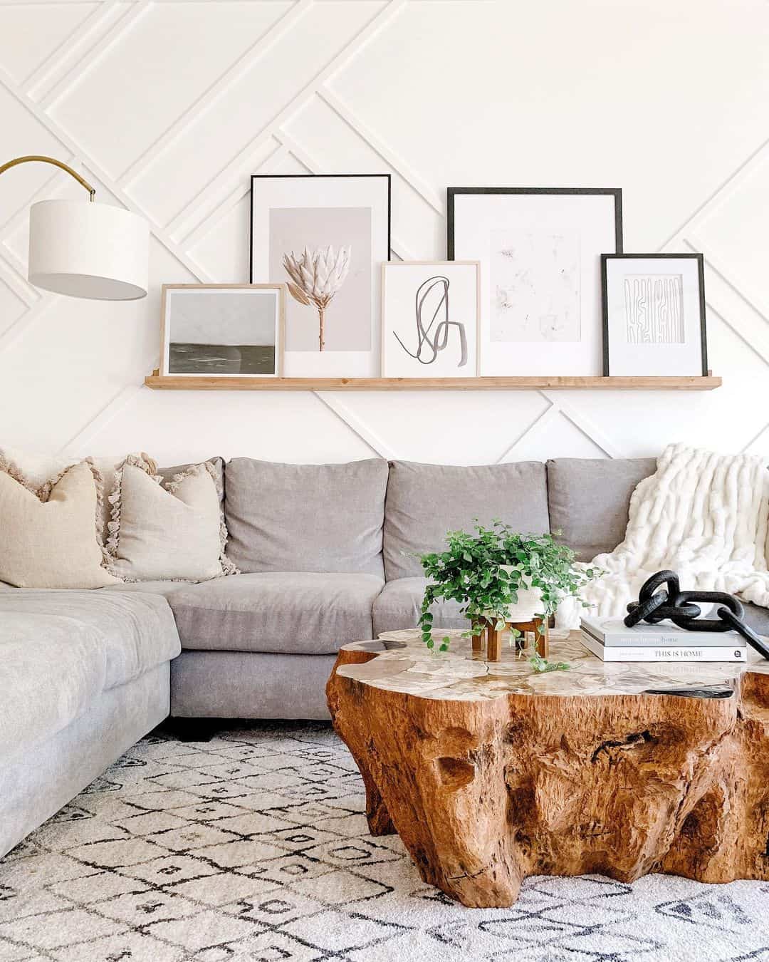 Layered Artful Arrangements on a Floating Shelf Above Sofa