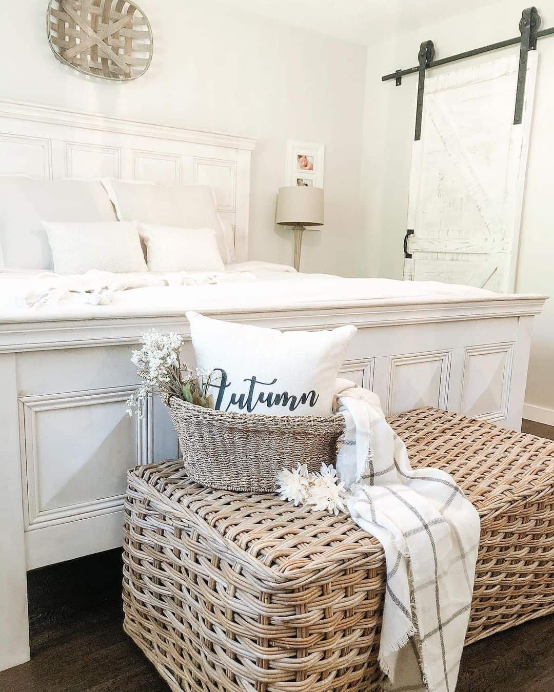 Woven Storage Ottomans Add Layered Texture Beside White Bed