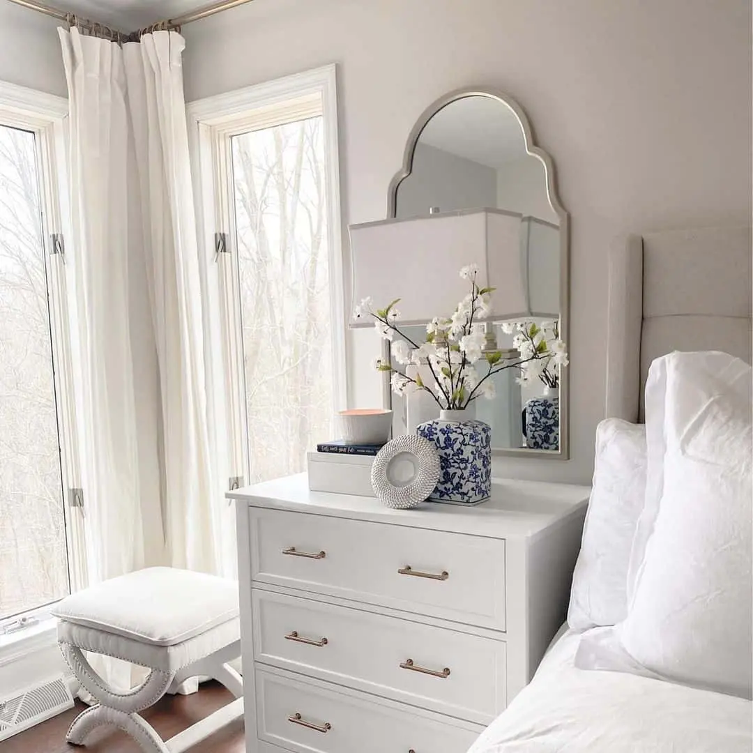 Scalloped Mirror Adds Architectural Interest Above White Dresser