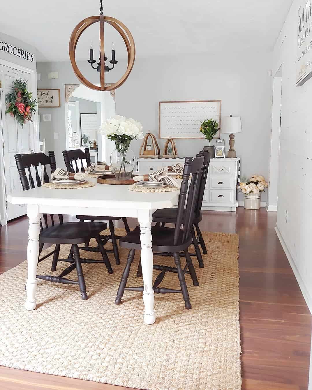 Jute Rug Under White Table Grounds Dark Chairs