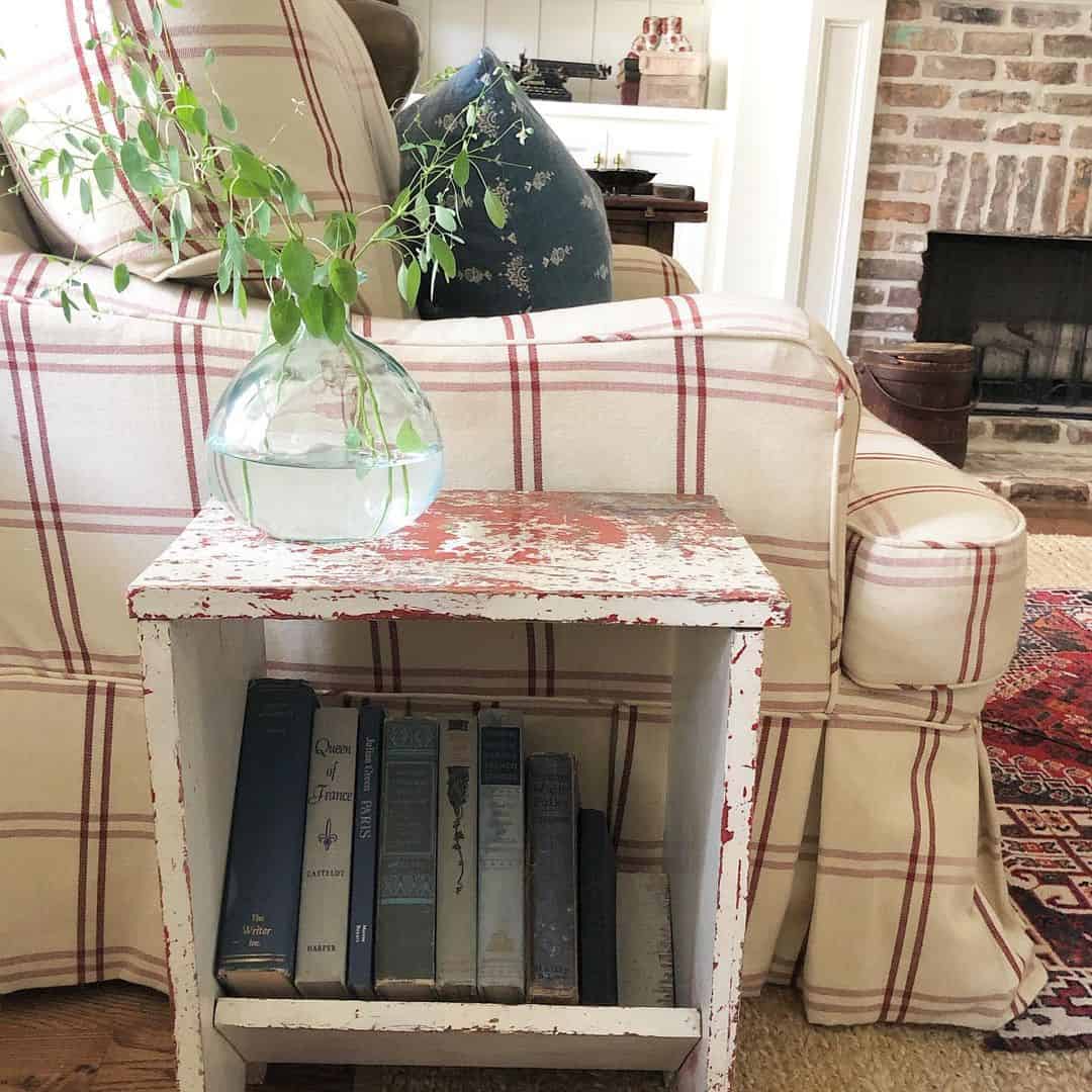 Distressed Wooden Step Table Holds Books and Greenery
