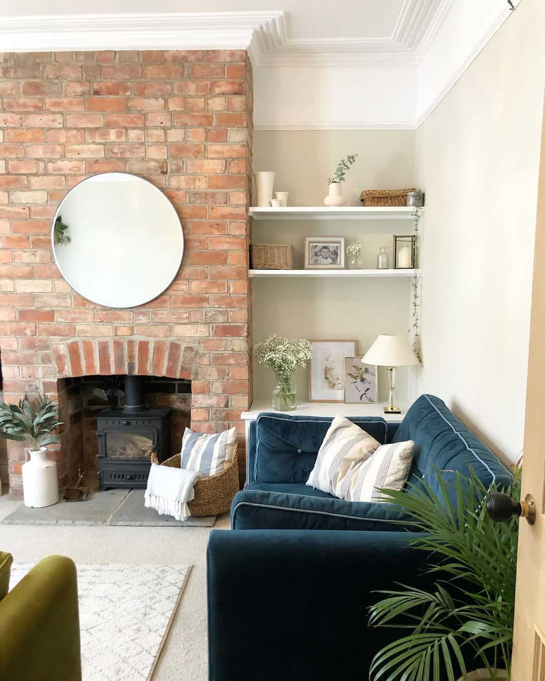 Simple Round Mirror Reflects Light on Brick Fireplace