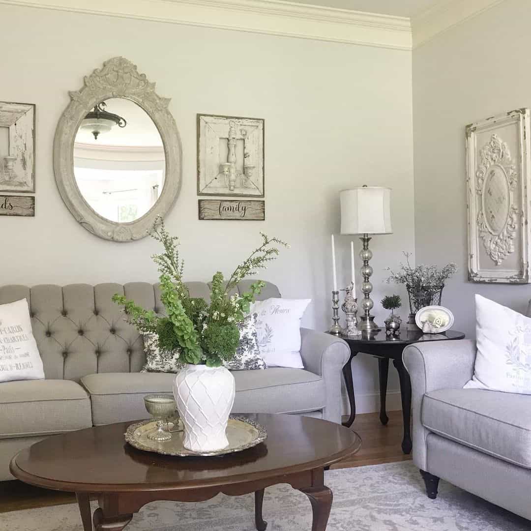 Ornate Oval Mirror with Distressed Frame Above Sofa