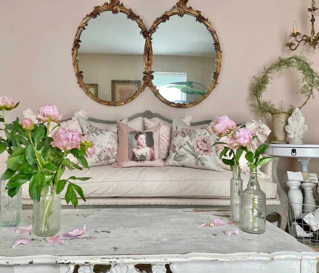 Pair of Ornate Gold Mirrors Frame a Softly Upholstered Sofa