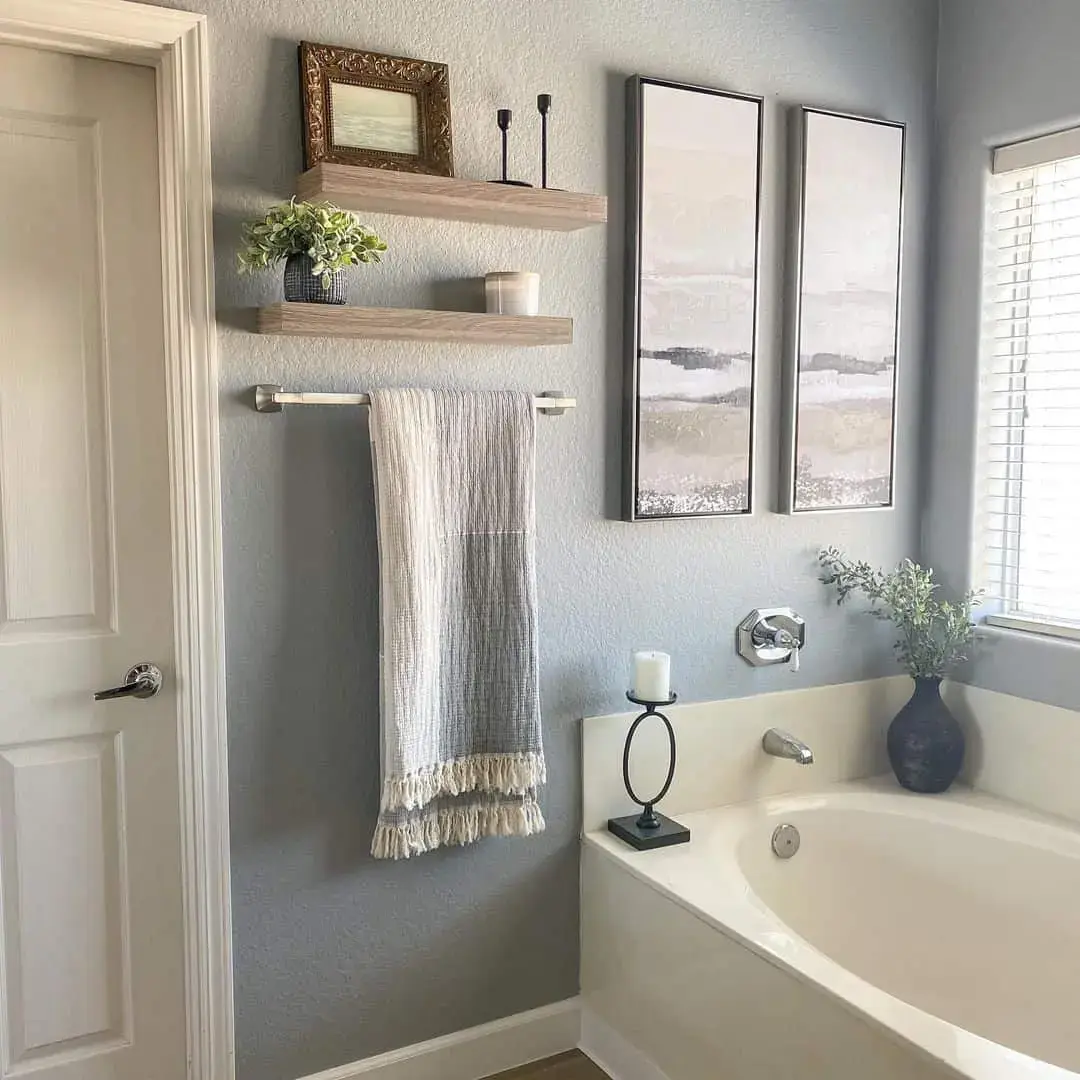 Floating Shelves Display Artful Accents Above Towel Bar