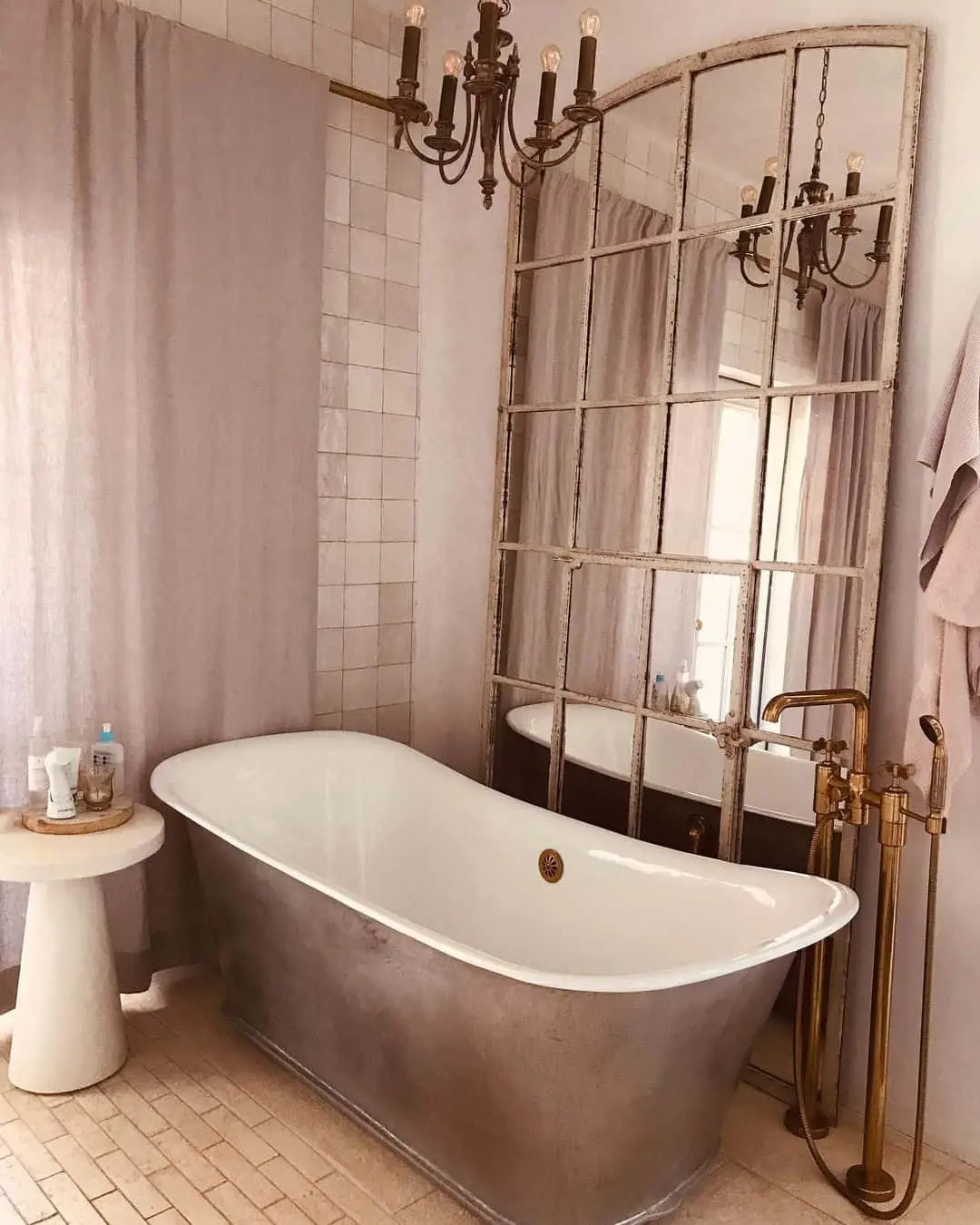 Windowpane Mirror Creates a Dramatic Focal Point Behind the Tub
