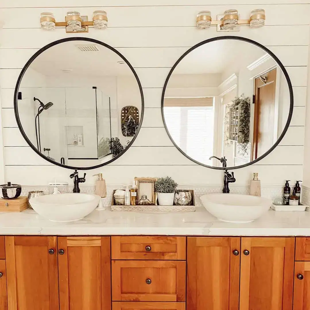 Large Circular Mirrors Frame Dual Vanities with Black Accents