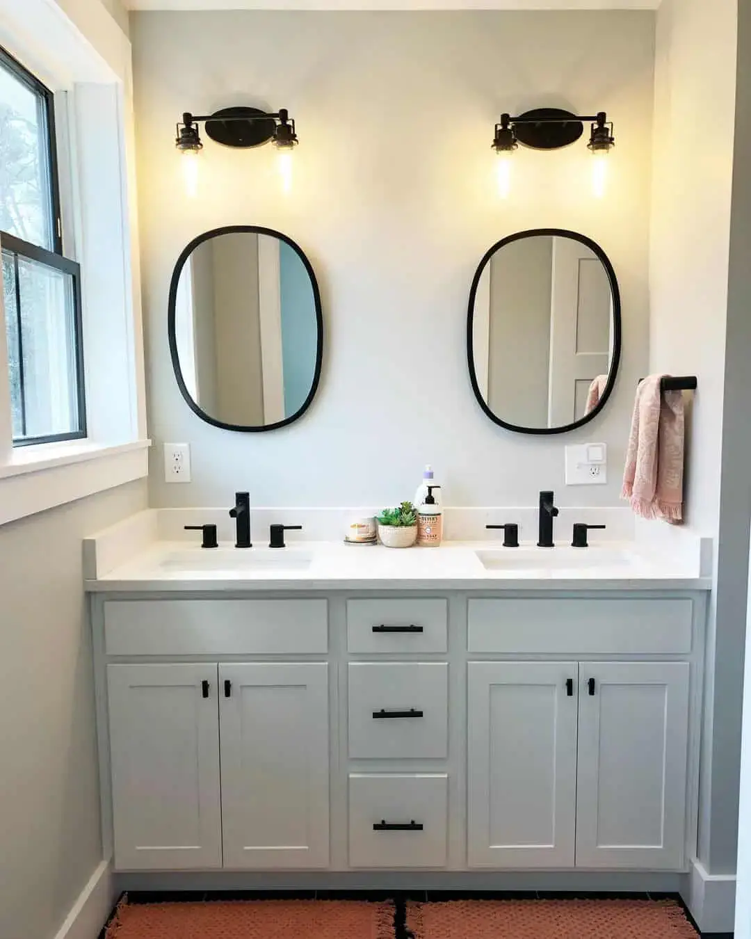 Oval Black Framed Mirrors Soften Dual Vanities