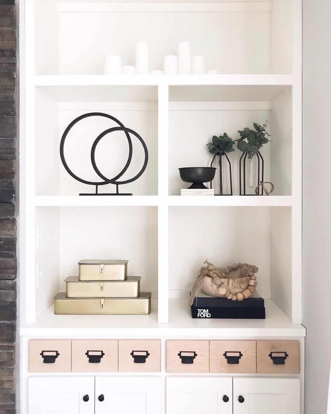 Stacked Gold Boxes Add Metallic Shine To White Shelving