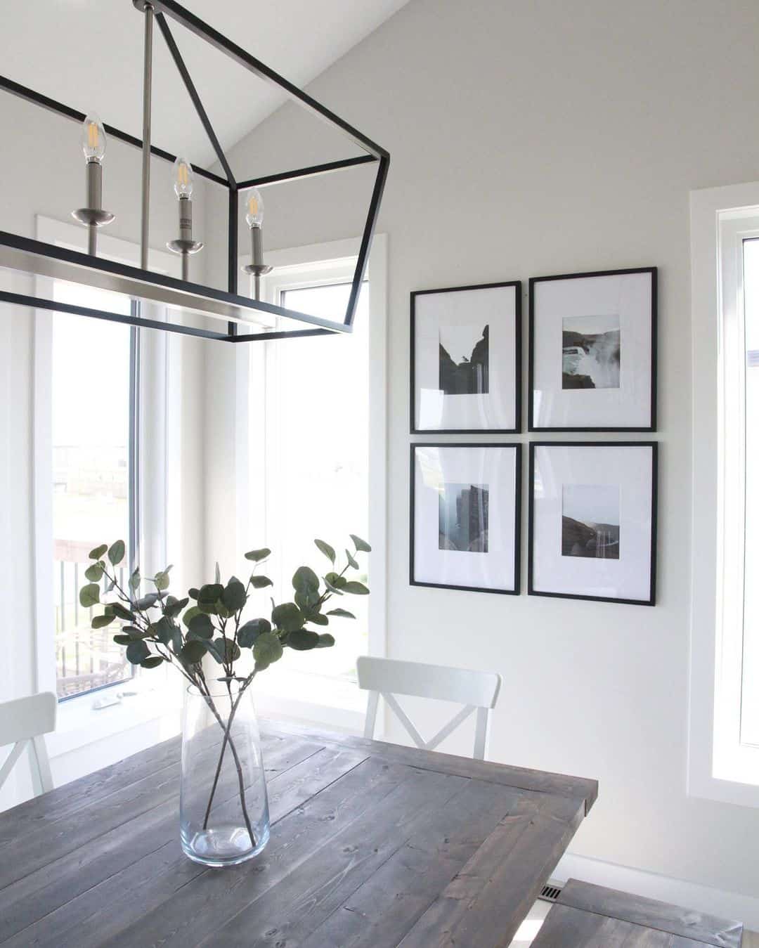 Black Framed Art Creates A Gallery Wall Above Dining Table