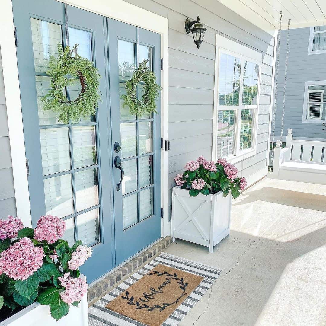 Blue French Doors Flanked by Lush Hydrangeas and Box Planters