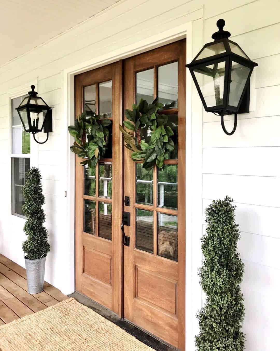 Double Wood Doors Adorned With Matching Leafy Wreaths