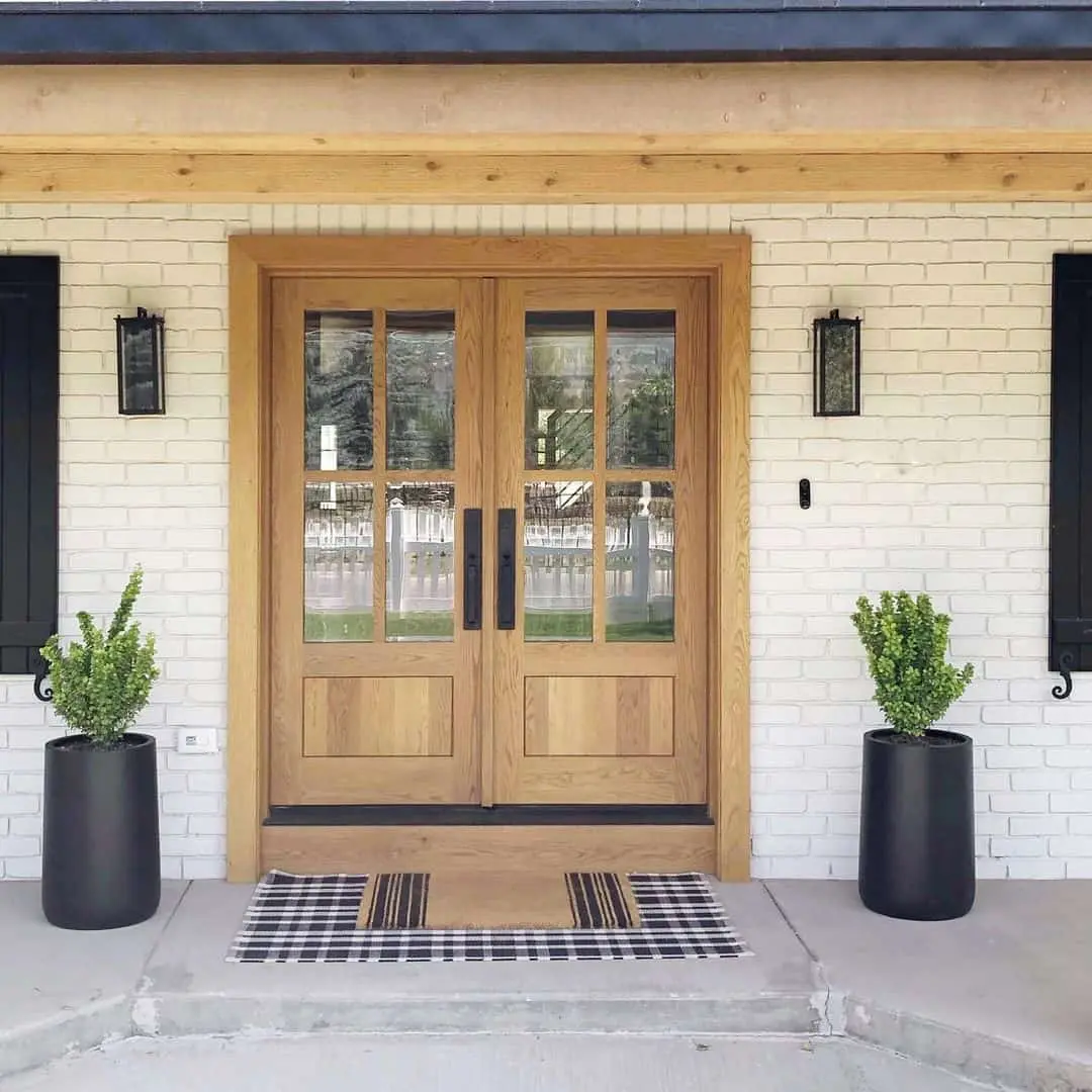 Double Wood Doors with Paned Glass and Black Planters