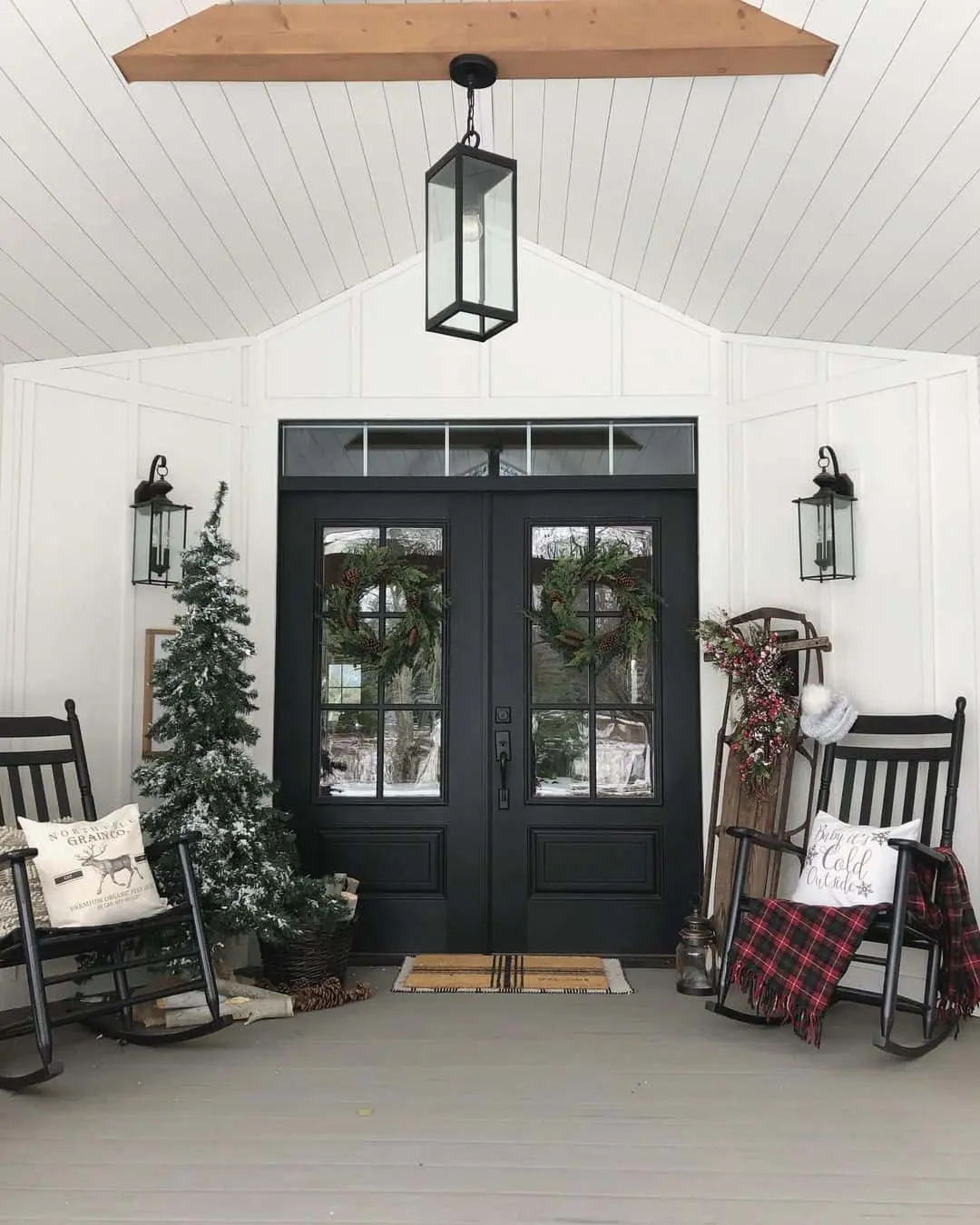 Double Black Doors with Pinecone Wreaths and Winter Decor