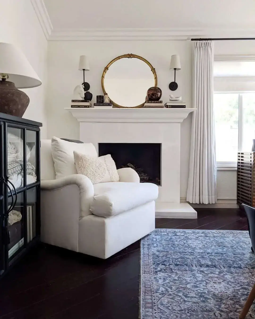 Round Mirror With Gold Frame Above Mantel