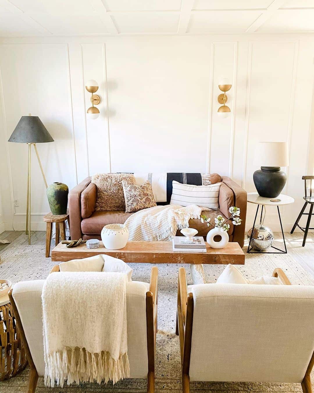 White wall paneling creates a textured backdrop for modern decor