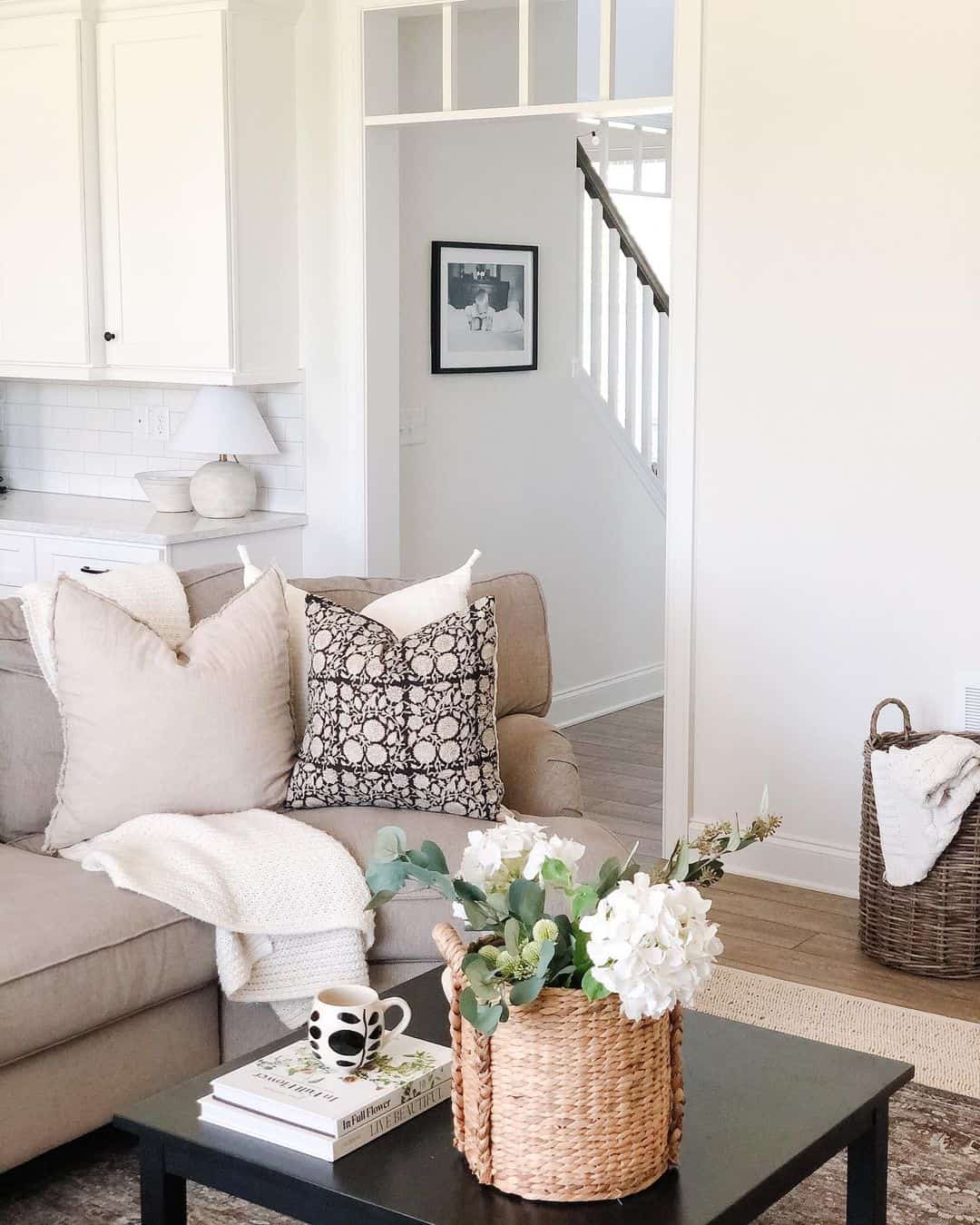 Woven basket with white flowers adds natural texture to coffee table