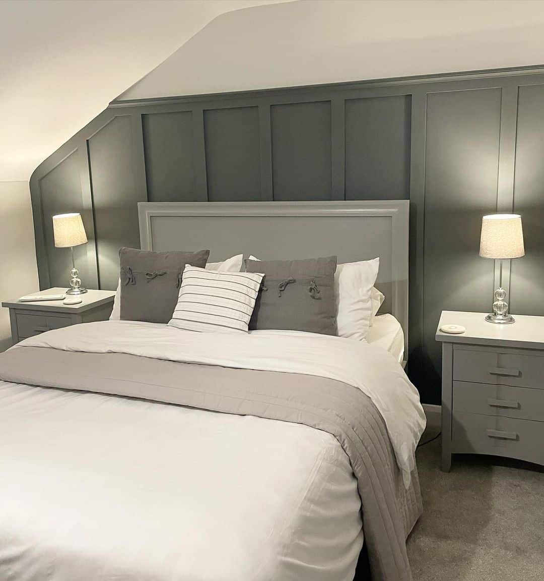 Dark Gray Paneling Adds Architectural Detail Behind the Bed