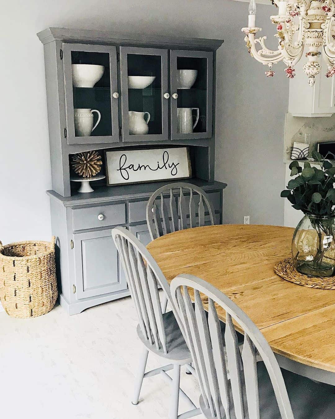 Gray Hutch With Glass Doors Displays White Dinnerware