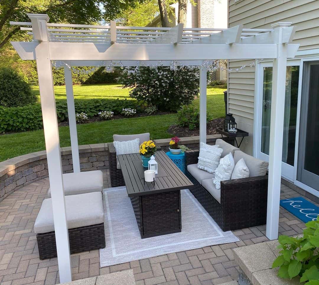 White Pergola Frames a Cozy Outdoor Seating Area