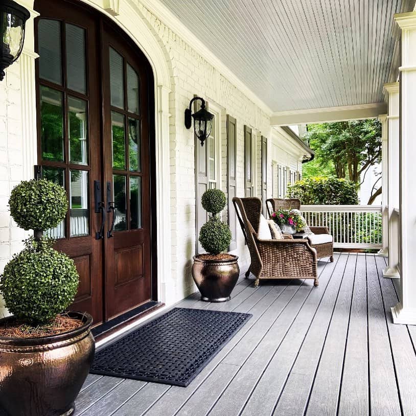 Boxwood Topiaries in Copper Pots Frame the Entry