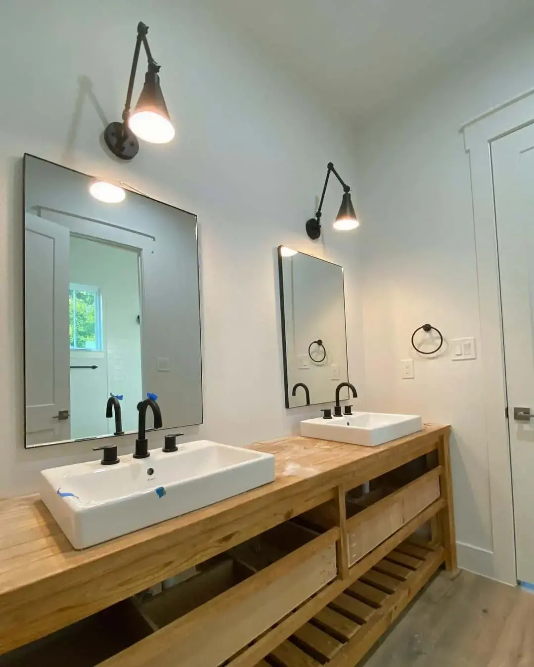 Adjustable Black Wall Sconces Cast Focused Light Above Mirrors