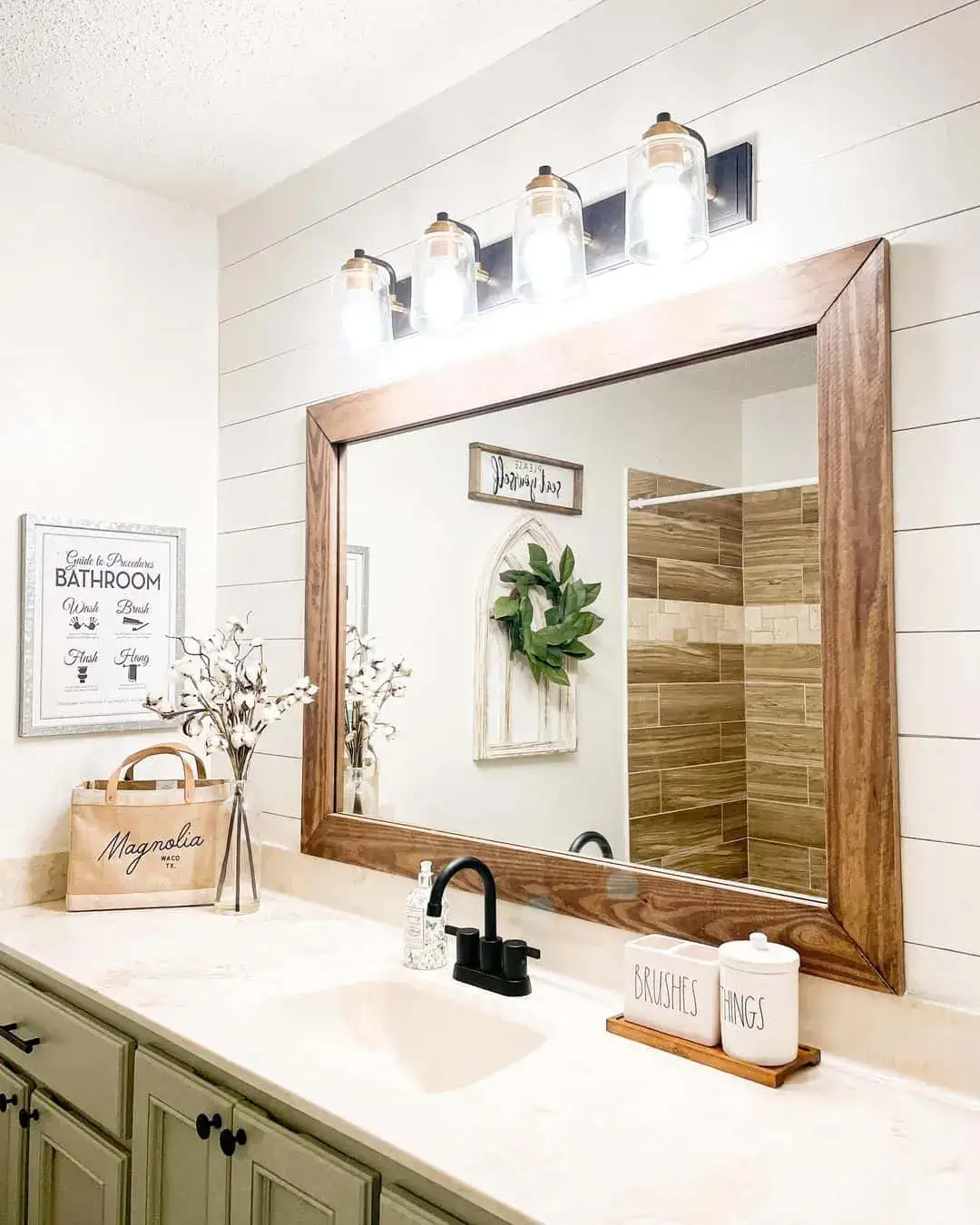 Clear Glass Cylinders With Brass Accents Illuminate the Vanity