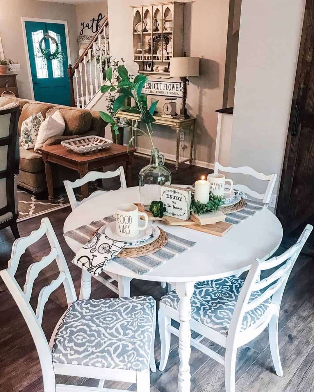 White Round Table With Patterned Upholstered Chairs