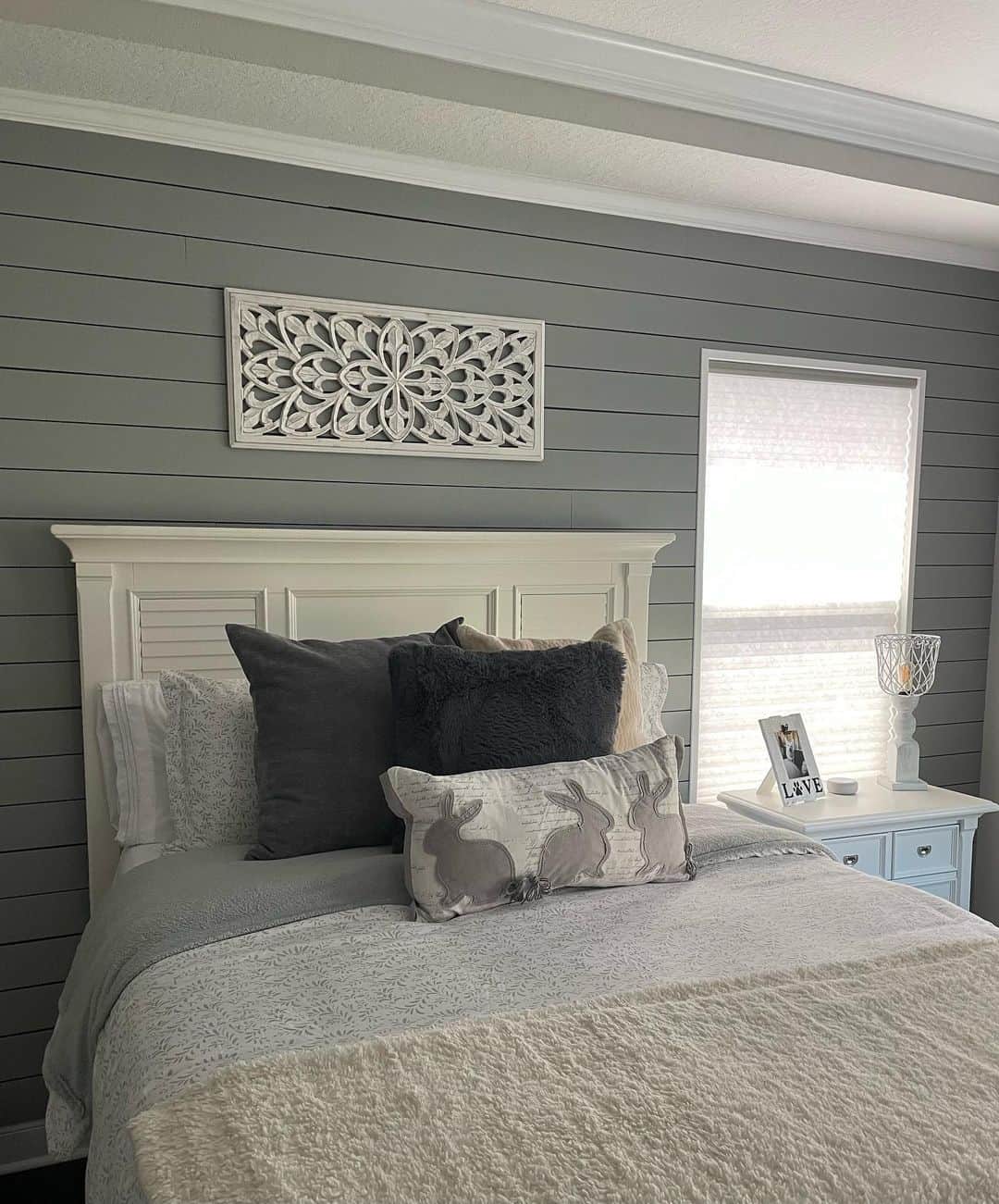 White Carved Wood Panel Adds Delicate Detail Above Bed