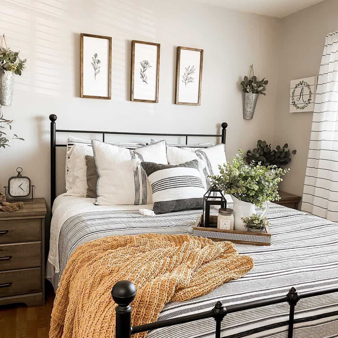 Three Framed Botanical Prints Add Subtle Greenery Above the Bed