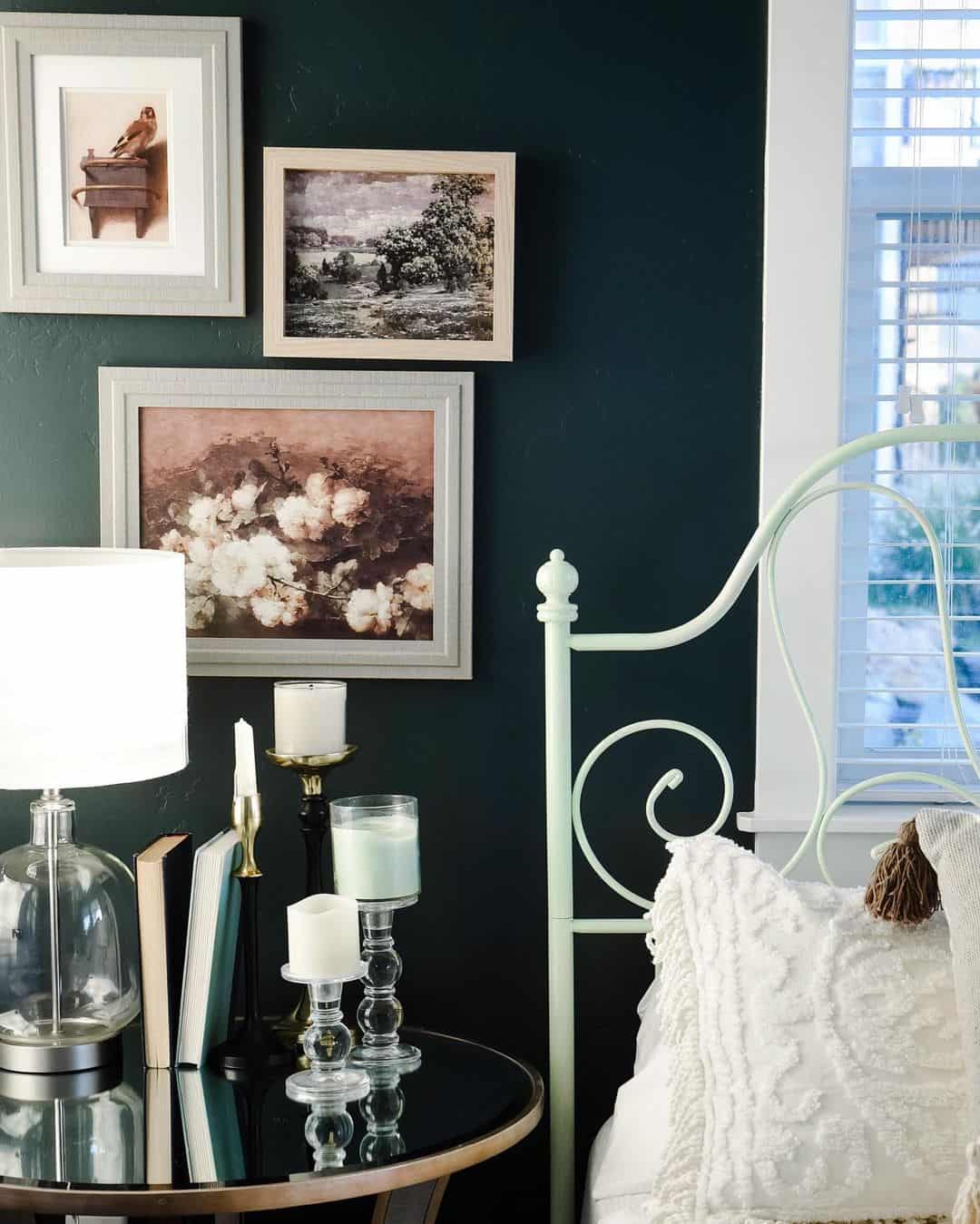 Gallery Wall of Vintage Prints Above a Light Green Bed