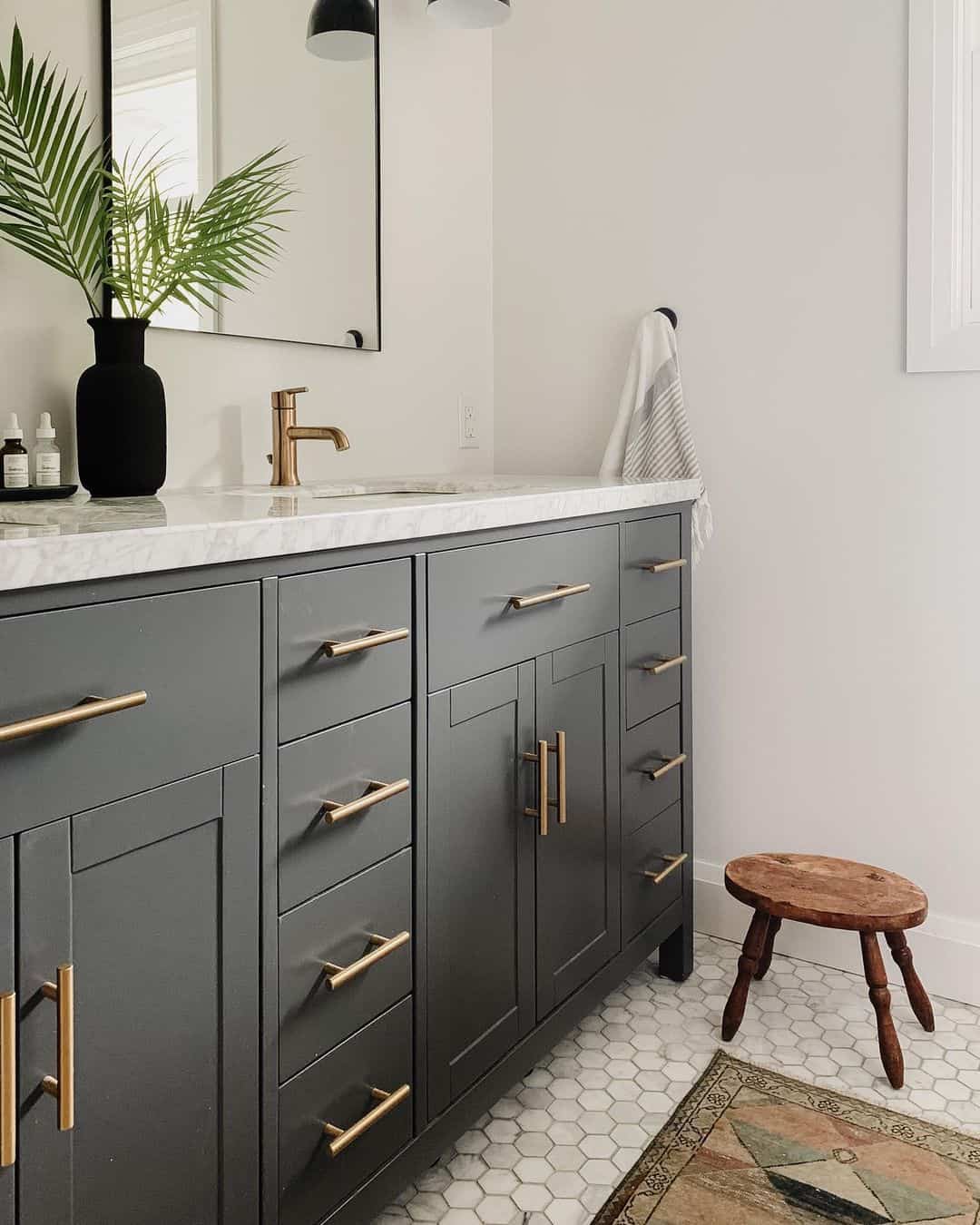 Warm Brass Hardware Adds a Luxe Touch to Dark Grey Vanities