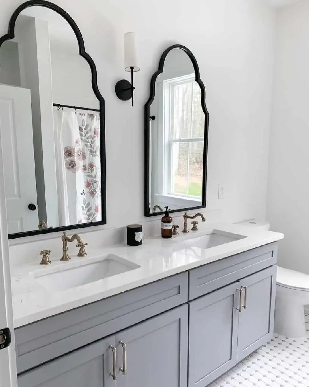 Arched Mirrors Frame the Vanity with Black Metal Edges