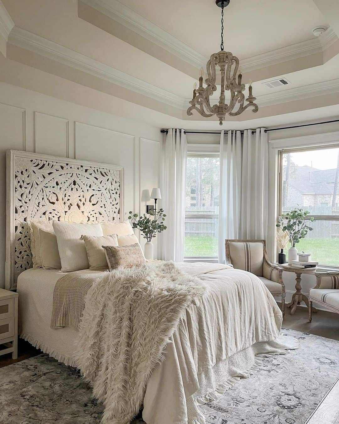 Textured Focal Point with an Ornate Carved Headboard