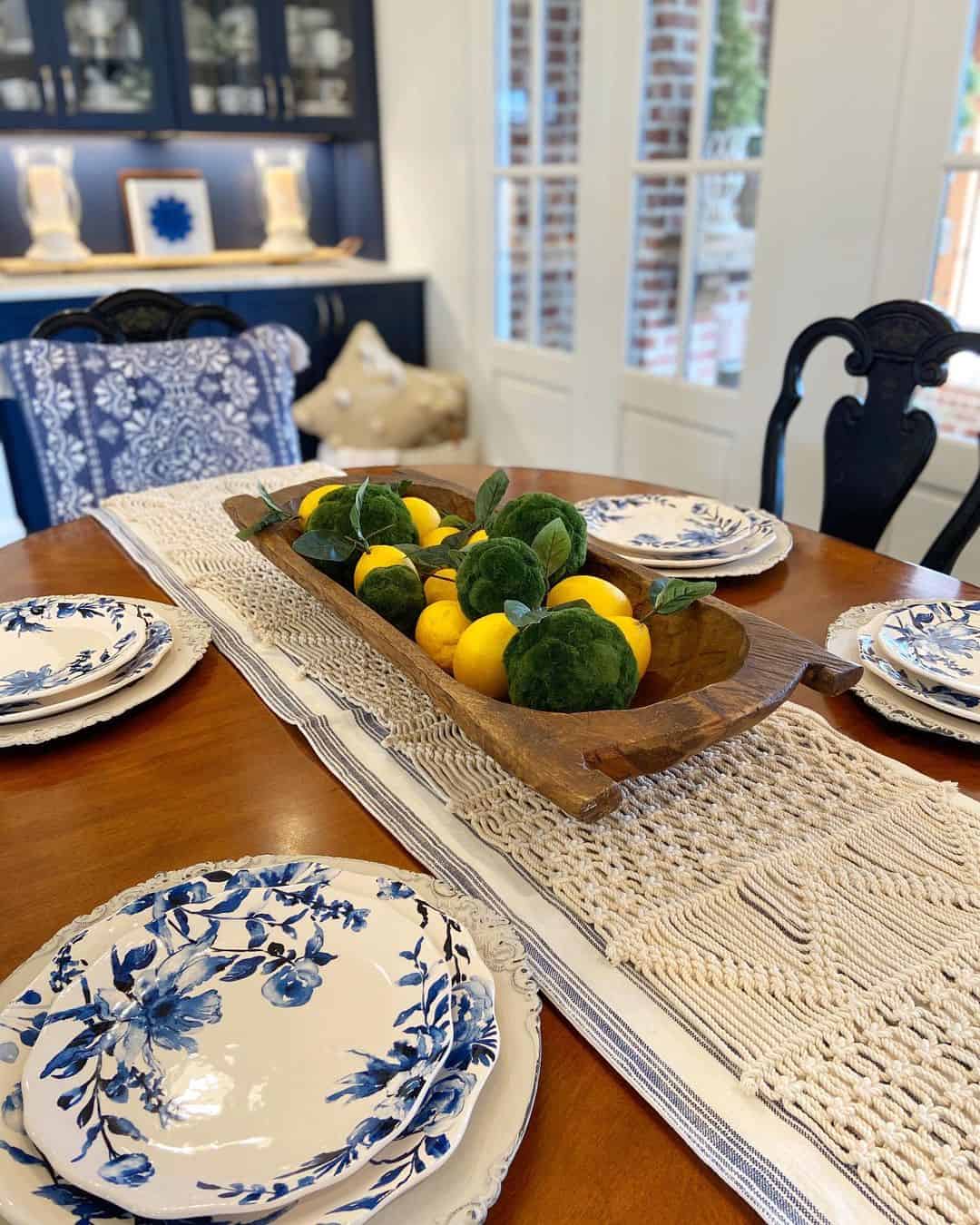 Wooden Dough Bowl Holds Lemons and Green Spheres