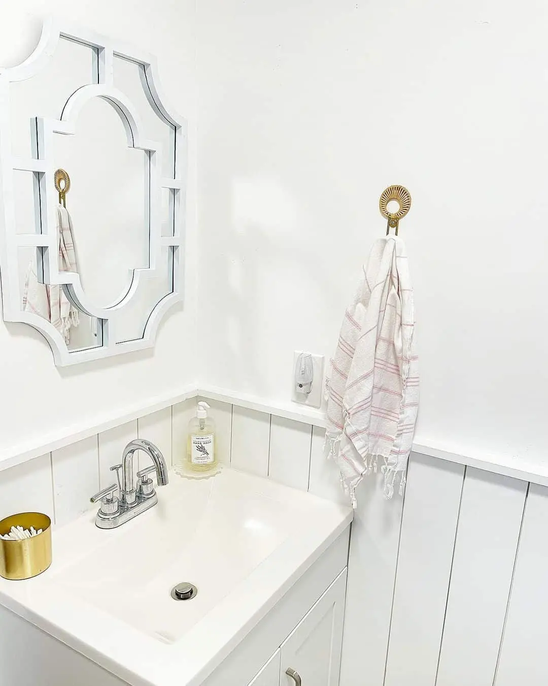 Ornate White Mirror Frames a Geometric Design