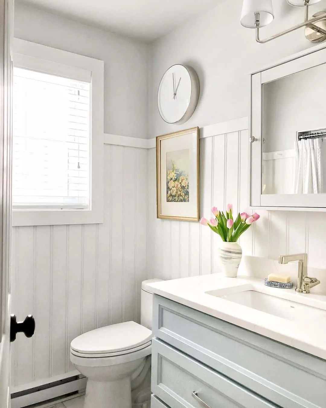 Round White Clock Adds a Clean Focal Point Above Wainscoting