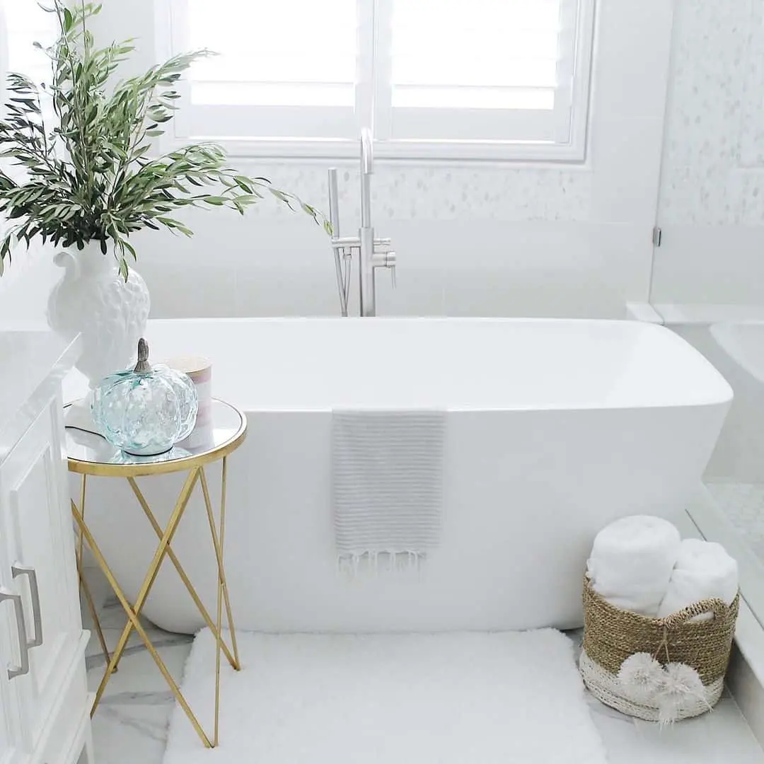 Introduce Glamour with a Gold Side Table Next to the Tub