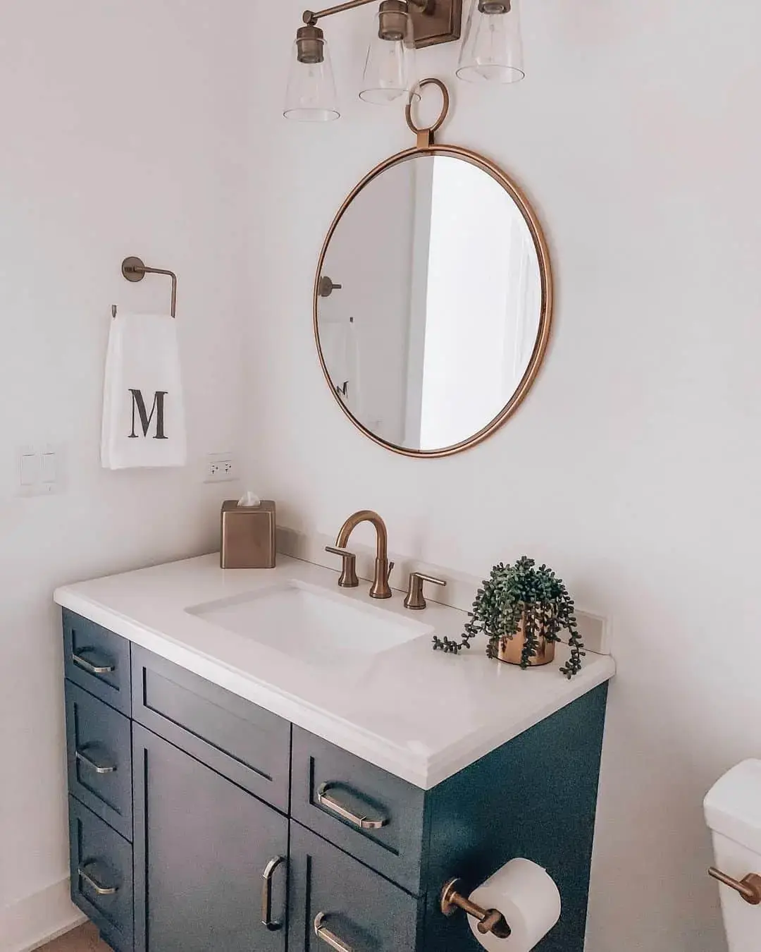 Sleek Gold Hardware Elevates a Dark Navy Vanity