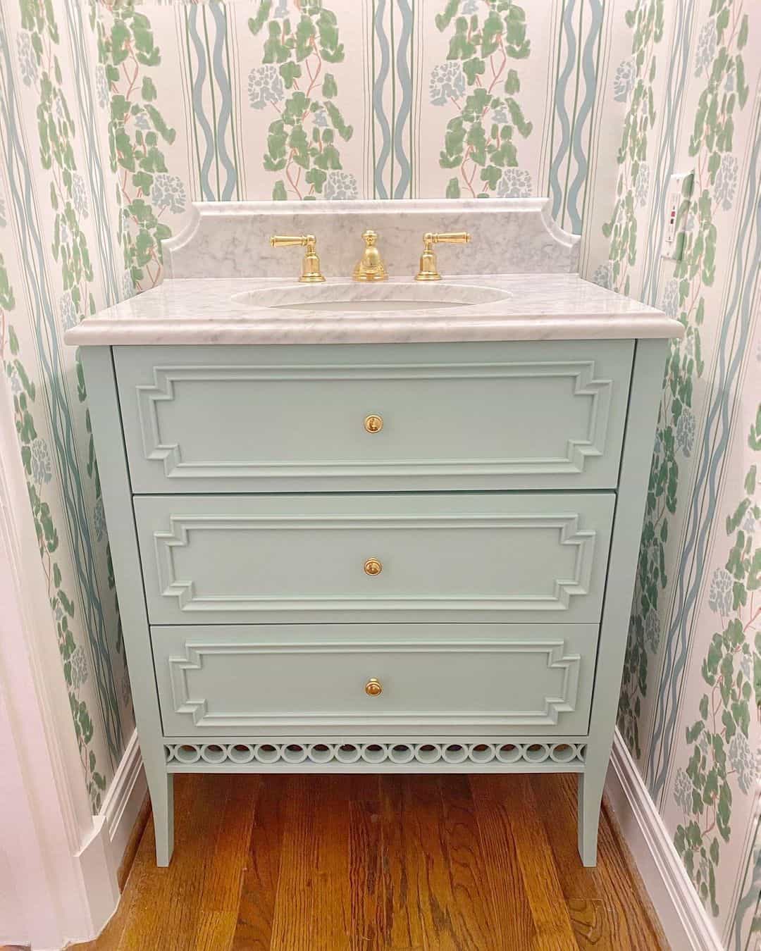 Light Blue Vanity With Geometric Trim and Gold Knobs