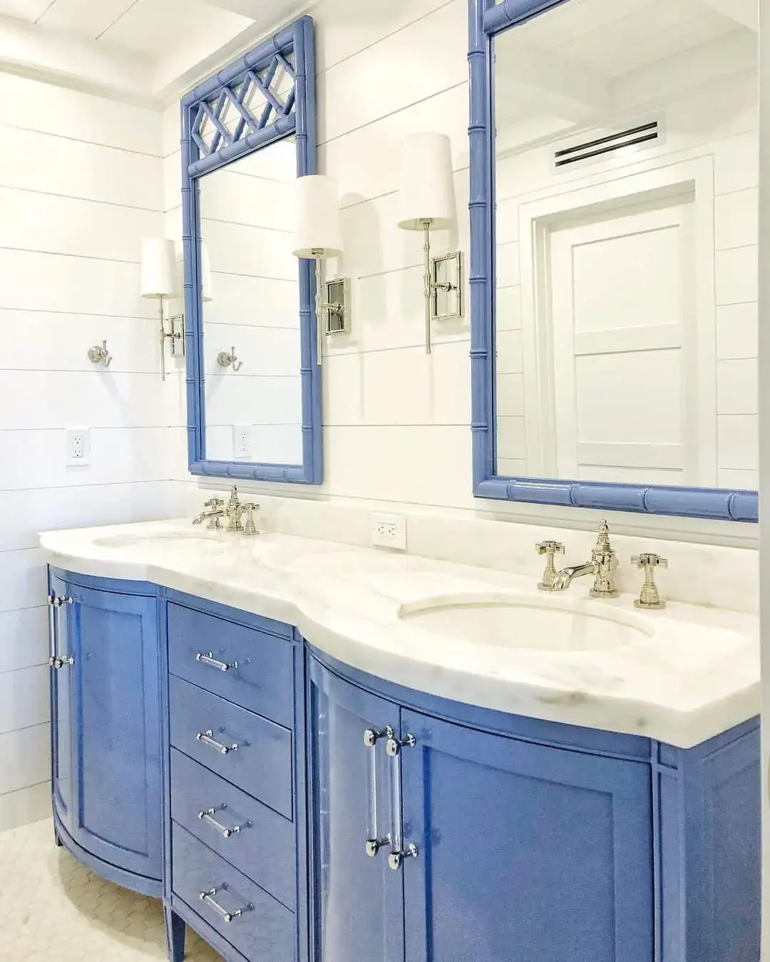 Playful Curves on a Periwinkle Vanity and Bamboo Mirrors