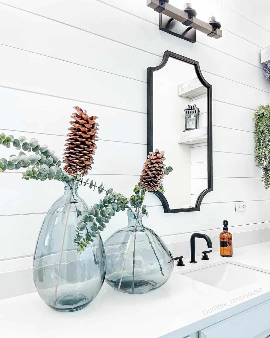 Glass Balloon Vases Hold Pinecones and Eucalyptus Branches
