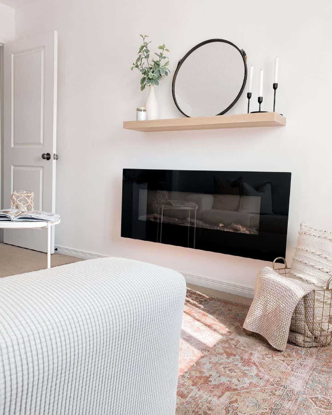 Frame Your Fireplace with a Round Mirror and Candlesticks
