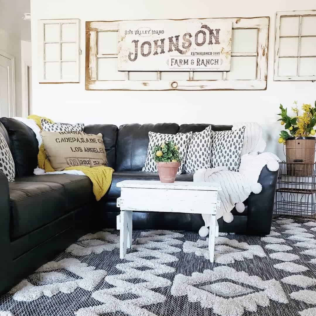 Distressed Farmhouse Sign and Window Panes Frame the Sofa
